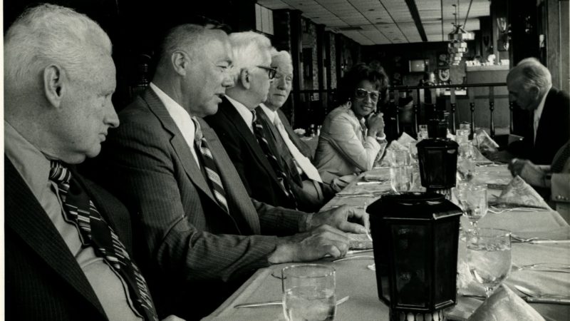 Margarite Syphax and group of unidentified men at luncheon, no date.